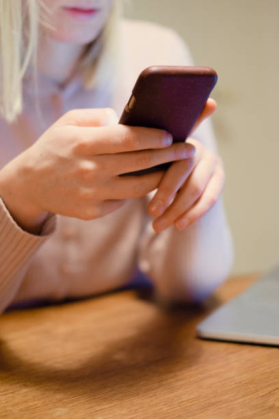 istock Young woman writing on smartphone at home 1200537005