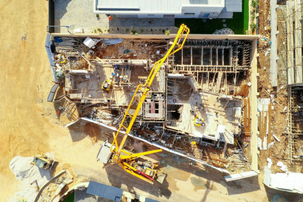 istock Concrete pump working on a large foundation pour at a new Suburban development site. 1200537131