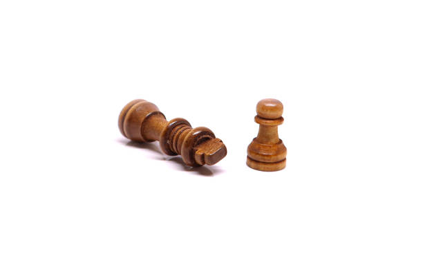 istock Chess coins on white background - King defeated by a pawn 1200537163