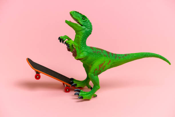 istock cute  green dinosaur toy  with skate 1200537169