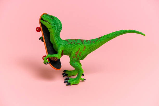 istock cute  green dinosaur toy  with skate 1200537265