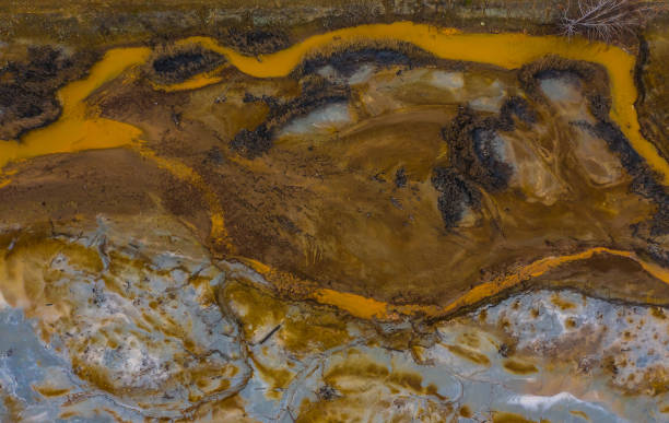 istock Pink colored water reservoir copper digging production site contamination territory ecological catastrophe drone flying over water surface aerial industrial landscape anthropogenic influense 1200541719