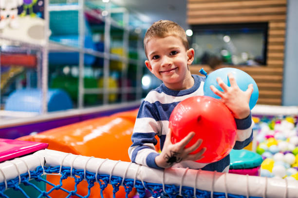 istock Cheerful little boy in playroom 1200541790