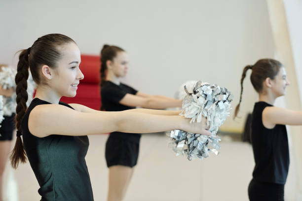 istock Girls dancing with pompoms 1200541965
