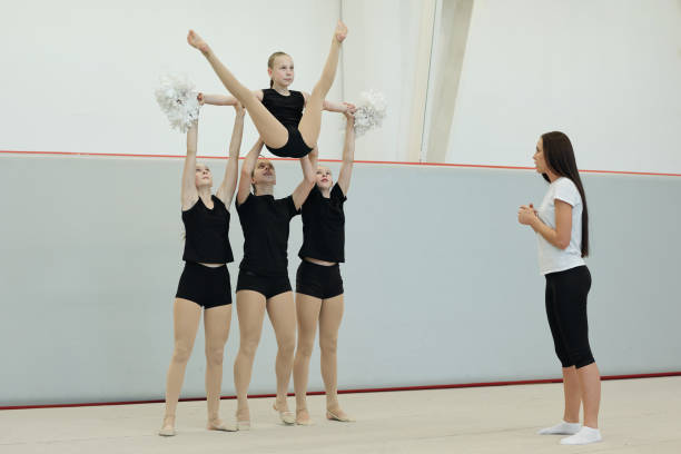 istock Performing split lift at cheerleading rehearsal 1200541972