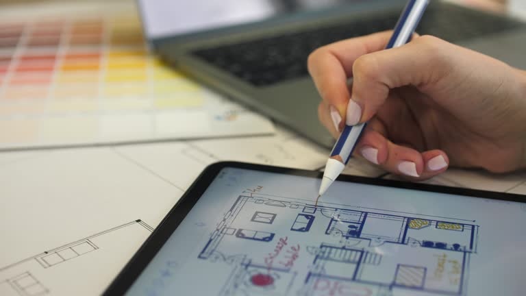 Architect Working on House Blueprint plan with Tablet PC