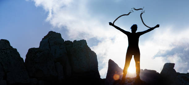 istock Silhouette of a woman with broken chains 1200546579