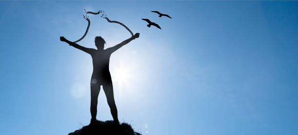 istock Silhouette of a woman with broken chains 1200546580