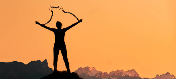 istock Silhouette of a woman with broken chains 1200546585