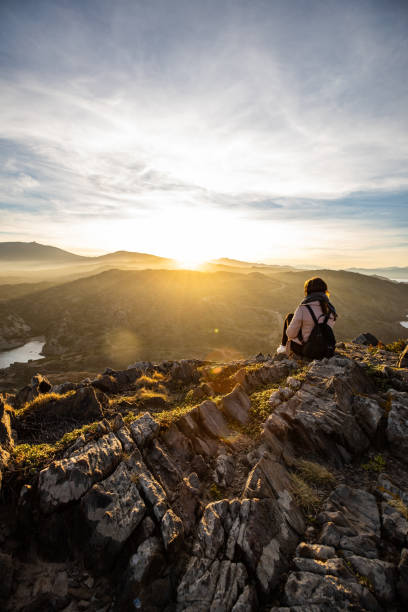 istock Beautiful woman standing on a cliff during sunset at Cap de Creus, in Spain with copy space 1200548430