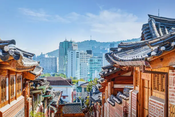 Seoul Bukchon Hanok Village Houses and Roofs. View to downtown Seoul Skyline. Historic Bukchon Hanok Neighborhood of Seoul, South Korea, Asia.