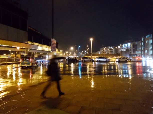 istock Night street outside Brighton train station during rain with reflections and crowds in Brighton 1200550308