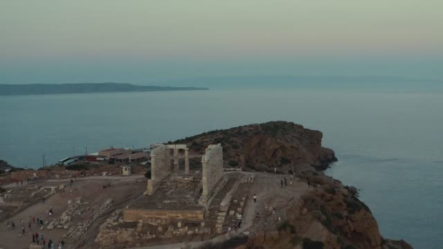 Aerial Shot of cape Sounio in Athens,Athens, Greece with the ancient Temple of Poseidon during the sunset at summer
