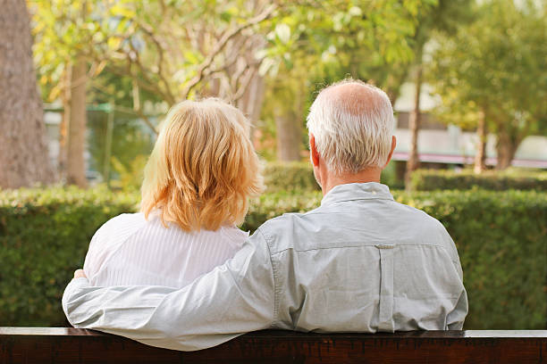 istock Senior couple sitting in the park 120055241