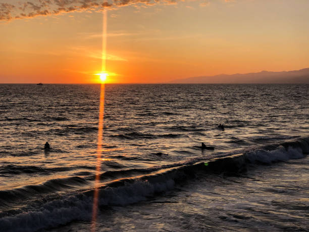 サーファーは南カリフォルニアのヴェネツィアの太平洋で一日の最後の時間を楽しむ - santa monica surfing beach city of los angeles ストックフォトと画像