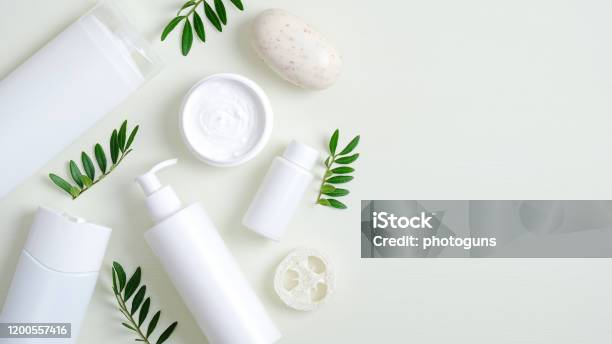 Organic Herbal Cosmetic Products On Green Background Top View Beauty Spa Cosmetic Bottle Packaging Hand Cream Lotion Bath Sponge Natural Soap And Green Leaves Minimalist Beauty Product Mockups Stock Photo - Download Image Now