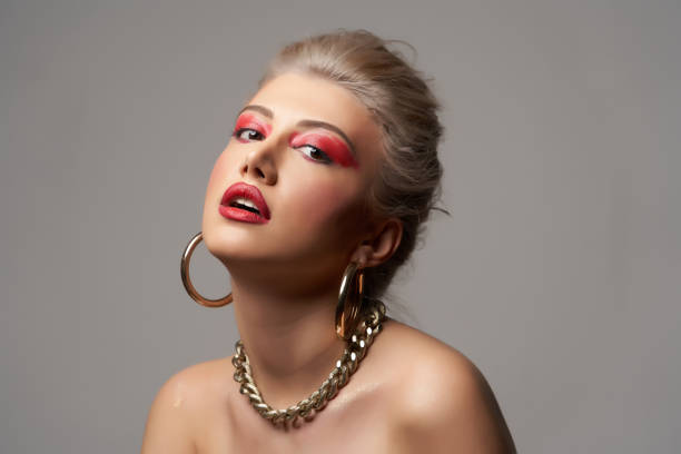 istock Beautiful woman with beautiful makeup over grey background with copy space 1200557424