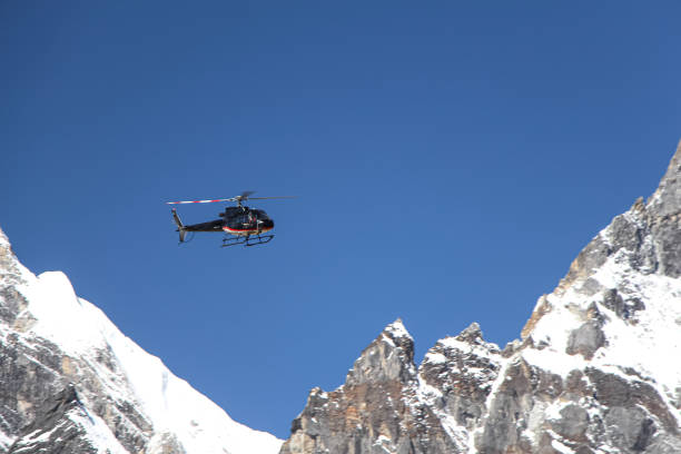 istock Black helicopter flies in Himalayas 1200559095