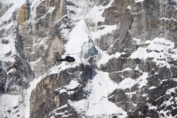 istock Black helicopter flies in Himalayas 1200559157