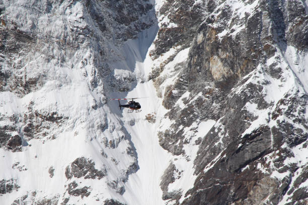 istock Black helicopter flies in Himalayas 1200559242