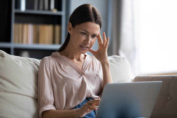 istock Confused woman frustrated with computer malfunction problems 1200561563