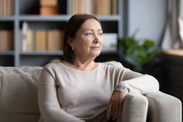 istock Pensive middle-aged woman look in distance thinking 1200561602