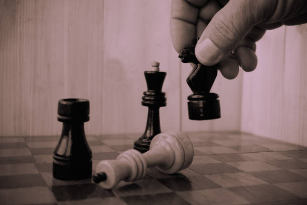 istock Playing chess. Player taking right action and making checkmate. Concept of running company and leading business 1200561681