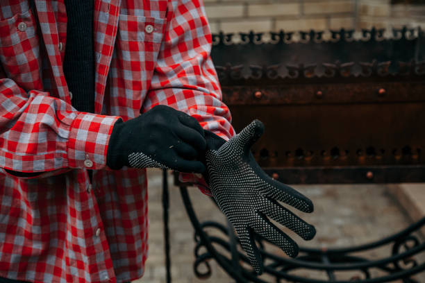 istock Man is wearing black work gloves 1200563383