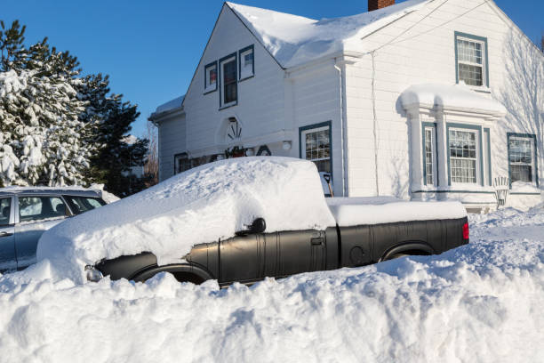 Winter Wallop Piles of snow bury a truck and home in a North American suburb. deep snow stock pictures, royalty-free photos & images