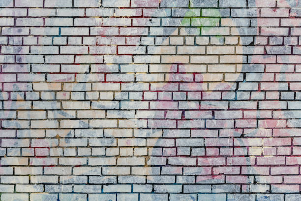 istock Beautiful horizontal texture of part of an old crashed brick colored wall in yellow red blue green brown hue is on the photo 1200568348