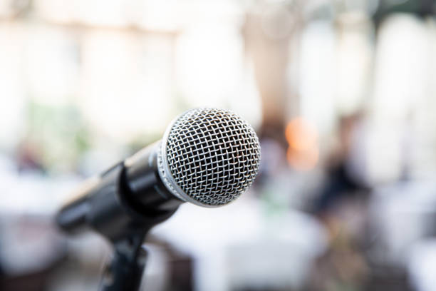 Microphone on blurred of speech in seminar room or speaking conference stock photo