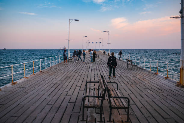 Limassol, Cyprus - November 2019: Wooden pier with people in Limassol, Cyprus, Mediterranean Sea landscape Limassol, Cyprus - November 2019: Wooden pier with people in Limassol, Cyprus, Mediterranean Sea landscape. limassol marina stock pictures, royalty-free photos & images