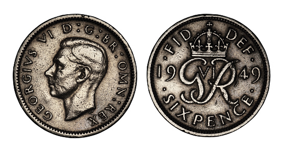 English six pence coin from 1949 on a white background