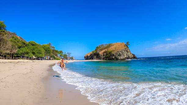 istock Koka Beach - A man having fun at the beach 1200571101