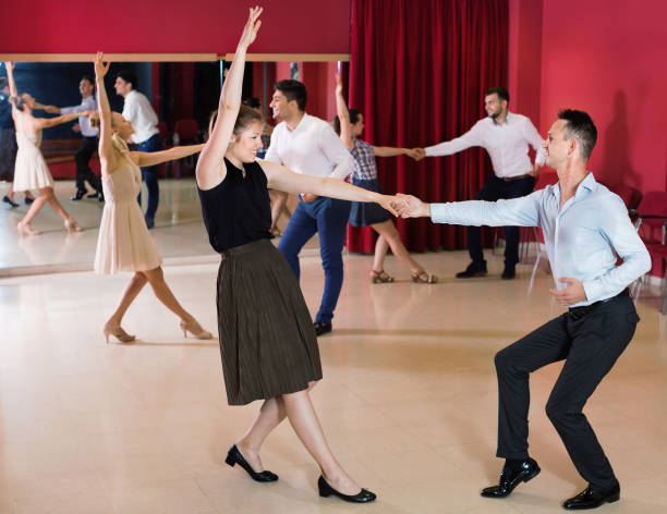istock Adult dancing couples enjoying active swing 1200572265