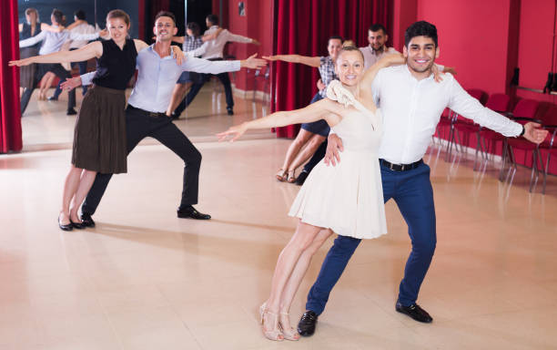 istock Happy young people dancing samba in dance class 1200572280