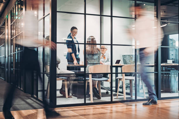 istock Inside view of an office building with blurred motion 1200572320