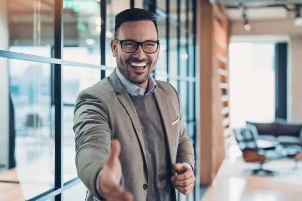 Businessman reaching out his hand for a handshake