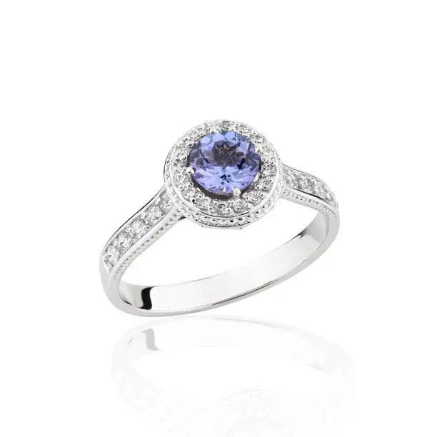 Wedding diamond ring isolated on a white background. Silver engagement ring with blue gemstone Tanzanite
