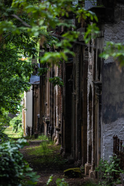 istock Old Tombs in a row in Prague Graveyard - Green trees and grass 1200575679