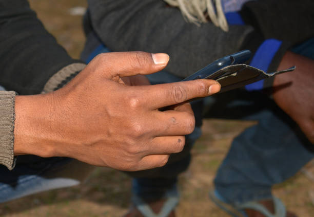 istock checking mobile phone app in winter in a rural town 1200577452