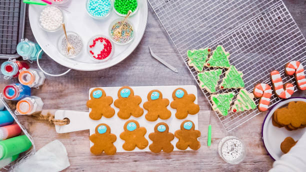 istock Decorating gingerbread and sugar cookies with royal icing for Christmas. 1200578708