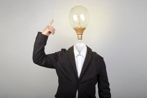 istock Headless businessman turns on the light bulb when having an idea. Surrealism. Conceptual image 1200580202