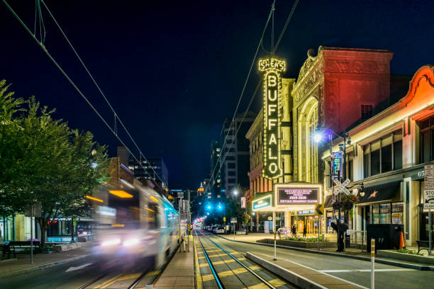 Buffalo, New York, USA - August 24, 2019: Lights from a passing streetcar pass in front of the Shea's Performing Arts Center in downtown Buffalo.