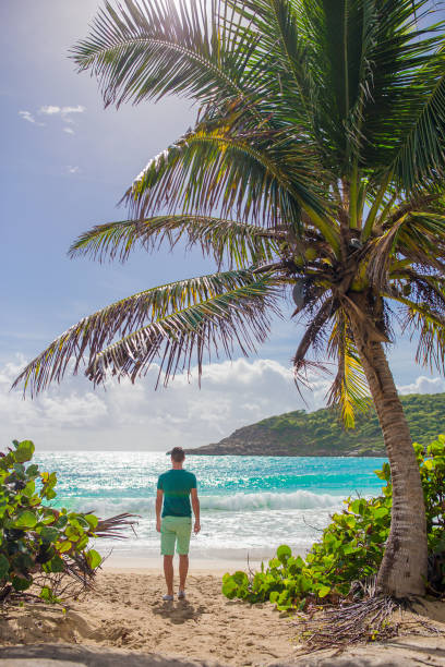 istock Young man enjoying summer vacation on tropical beach 1200583256