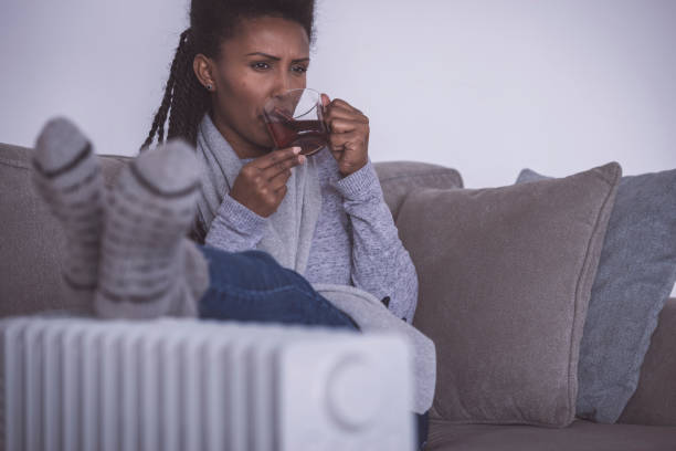 istock Woman drinking hot tea, heating feet at home. 1200584305
