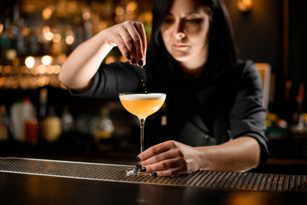 istock Bartender sprinkles the sour mix cocktail accurately 1200586167