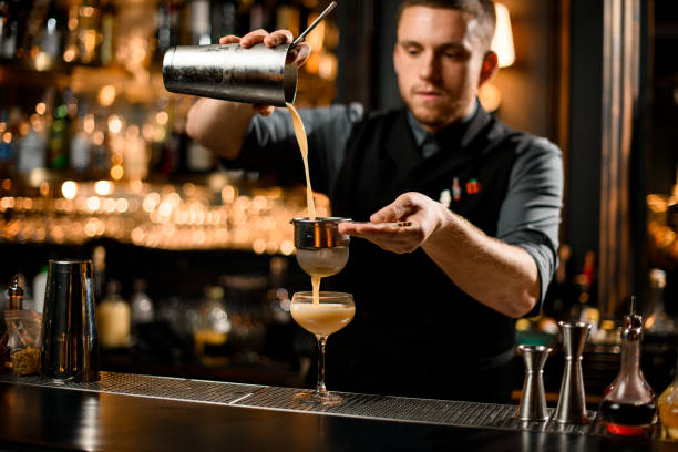 istock Bartender flows shaked mix through the sieve 1200586722