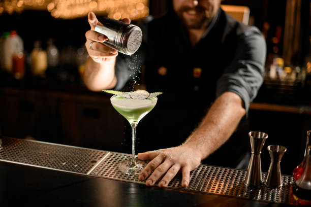 istock Bartender sprinkles drink with eucalyptus and slice of lemon 1200586843