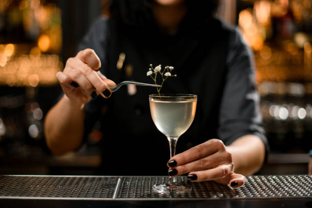 istock Close-up of bartender putting small branch in cocktail 1200586870